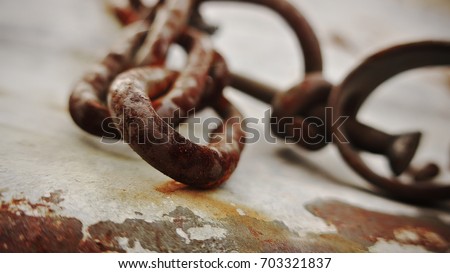 Freedom from old rusty shackles. Monochrome photo. Royalty-Free Stock Photo #703321837