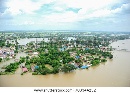 Thailand floods, Natural Disaster, 
Helicopter surveys flood Royalty-Free Stock Photo #703344232