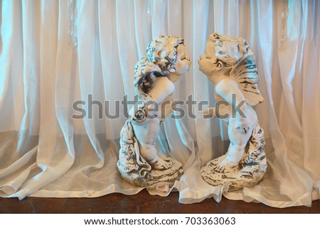 Original statuettes in the form of angels from stucco on a wedding day