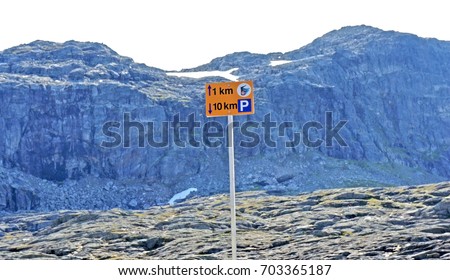 A sign that showes how many kilometers have passed and how much is left to pass, last kilometer, hiking to the Trolltunga cliff (The Troll's tongue), Odda, Norway