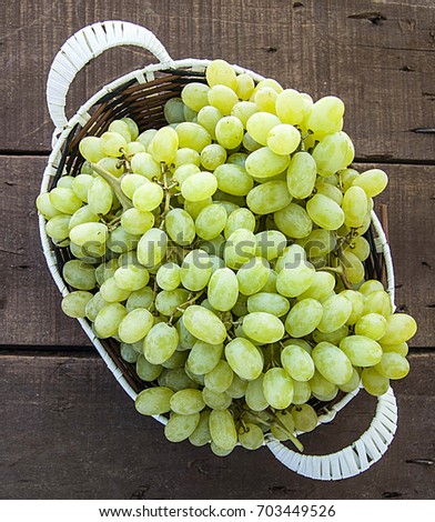 Very fresh grapes in the basket, bunch of grapes on the wooden floor, grape bunch of pictures in different concepts.Natural grape clusters, vineyards and grapes,