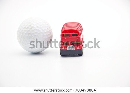 Golf ball and red double decker bus  in  London England on white background