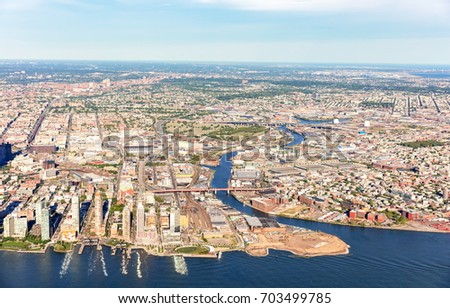 Aerial view of Brooklyn and Queens, New York City with East river in the foreground