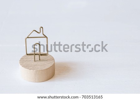 House shape stand clip for clipping note background. Other meaning is family house or investment property.
