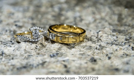 Golden Wedding Ring with Diamond on Stone background 