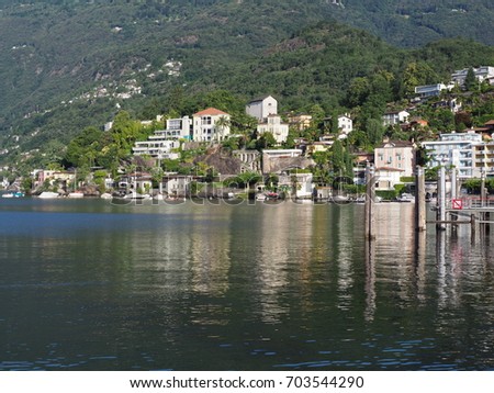 ASCONA travel city in SWITZERLAND with scenic view of beauty Lake Maggiore at canton of Ticino and slope of alpine mountain range landscape at swiss Alps in 2017 warm sunny summer day, Europe on July.