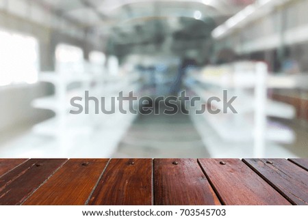 Look out from the table, blur image of empty shelves in the store as background.