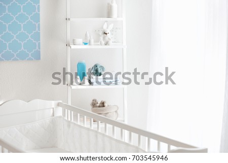 Beautiful light room with crib and toys on shelves