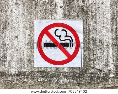 No smoking sign on concrete wall background