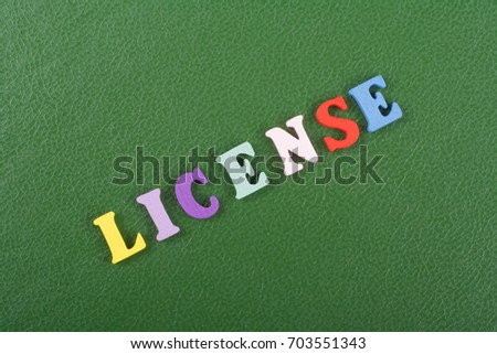 LICENSE word on green background composed from colorful abc alphabet block wooden letters, copy space for ad text. Learning english concept