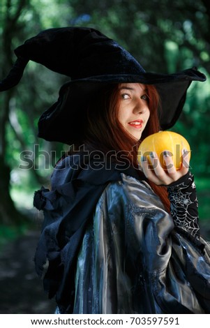 Image of witch with pumpkin in hand