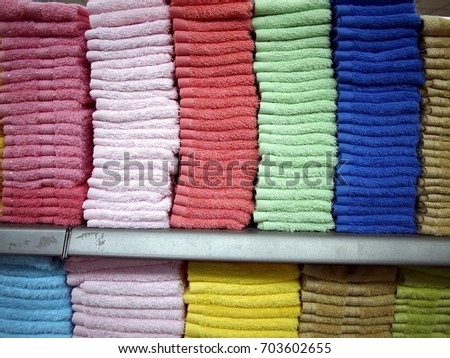 Photo of colorful towels stacked on a shelf