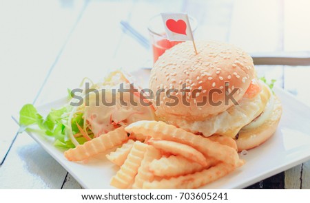 Gourmet Tasty Steak Burgers with Ham Slices on a Wooden Tray with Potato Wedges and Dipping Sauce / soft focus picture