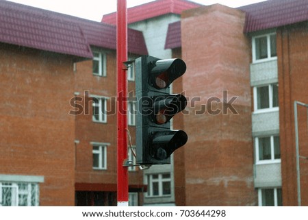 A traffic light against the background of multi-storey apartment buildings. School of traffic, driving school, traffic rules. Simulator, trainer for pedestrians and drivers.