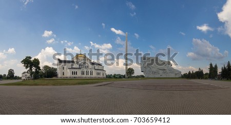 Panorama of cityscape, square and church, blue sky and storm clouds before rain