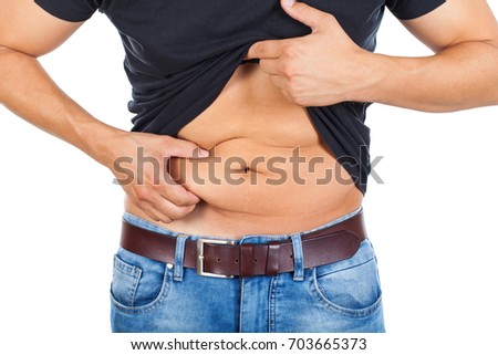 Close up picture of a caucasian young man's fatty abdomen on isolated background