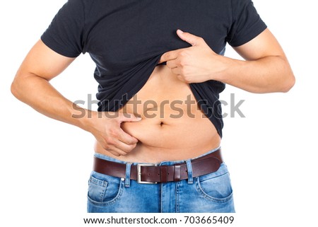 Close up picture of a caucasian young man's fatty abdomen on isolated background
