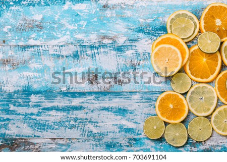 Citrus fruits. Oranges, limes and lemons. Over wood table background with copy space.