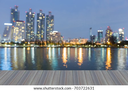 Opening wooden floor, Twilight blurred bokeh city downtown waterfront, abstract background
