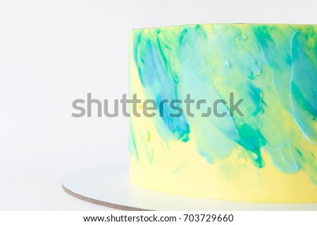 Cake with whipped yellow and green cream. Picture for a menu or a confectionery catalog. Close up