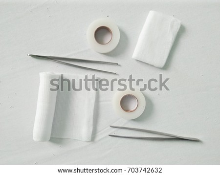 Gauze,Orthopedic Bandage,Transpose ,Tissue Forceps and Toot Forceps on Bed white the Medical for Wound Dressing and Set Suture Concept. 