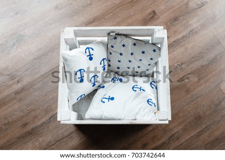 Wooden box with pillow on wooden floor