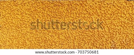 Closeup surface of rough yellow plastic background.