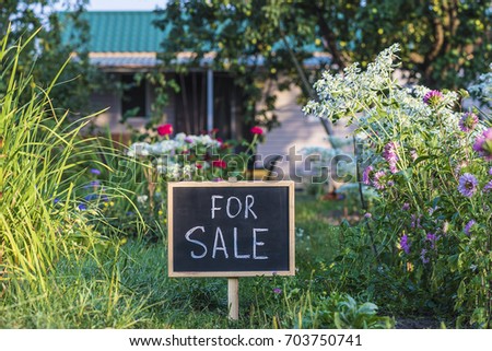 sign board "for sale" in front of a house/property for sale concept