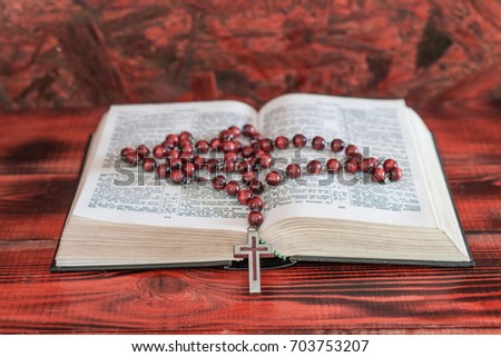 Bible and a crucifix on an old table. Beautiful background.Religion concept.
