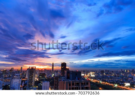 dramatic Bangkok city skyline at sunset, long exposure photography for clouds movement, crepuscular rays