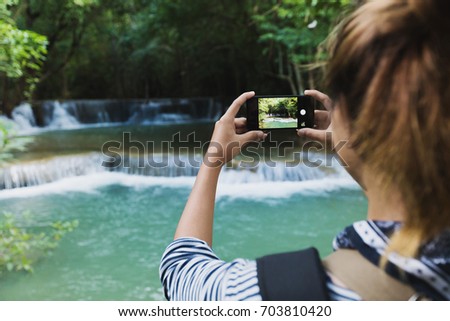 tourism use smartphone taking photograph