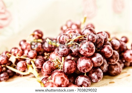 red grapes on wooden plate, blurred picture, selective focus