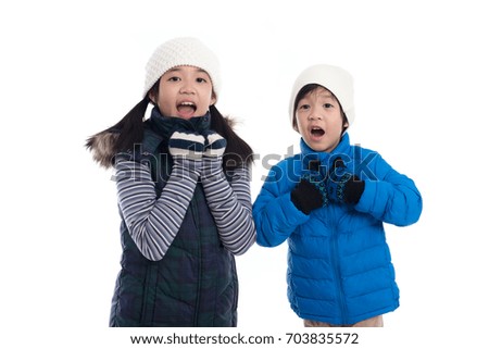 Cute Asian children in winter clothes is surprise and so happy about it on white background isolated
