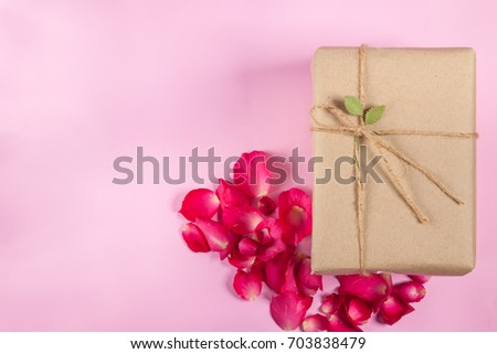 vintage gift box and rose petals On the pink background