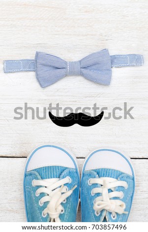 Set of a little gentleman. Sneakers, mustache, bow tie. Vertical photo