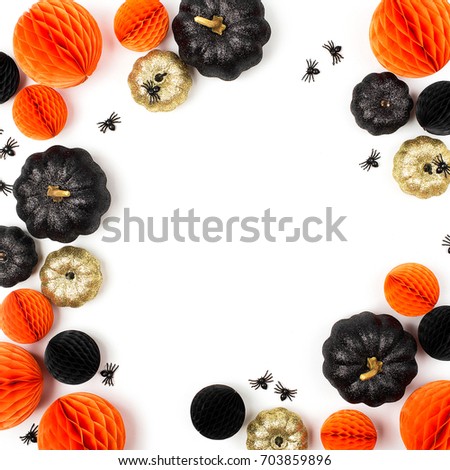 Shiny Decorative Pumpkins and Honeycomb balls. Halloween decorations. Flat lay, top view trendy holiday concept.