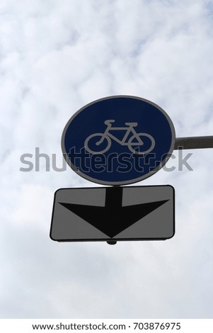 Sign - a path for cyclists with an arrow on the sky background