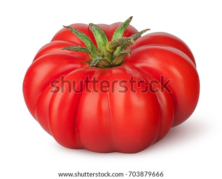 Fresh heirloom tomato isolated on white background Royalty-Free Stock Photo #703879666