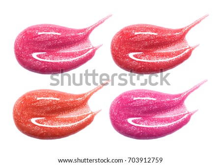 Set of different lip glosses pastel color smear samples isolated on white. Smudged makeup product sample. Royalty-Free Stock Photo #703912759