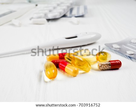 a lot of pills on white wooden background, copy space for text, concept of medicine and health