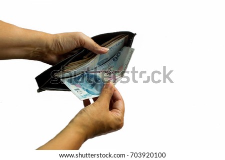Hand taking out hundred Turkish Lira from wallet on the white background with copy space.Above view