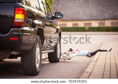 Accident. Small girl on the bicycle is hit by the car