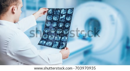 Doctor examine MRI picture. Medical equipment. Royalty-Free Stock Photo #703970935