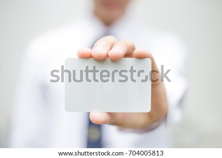 soft focus.hand business man holding business card with empty space for text. on blurred background