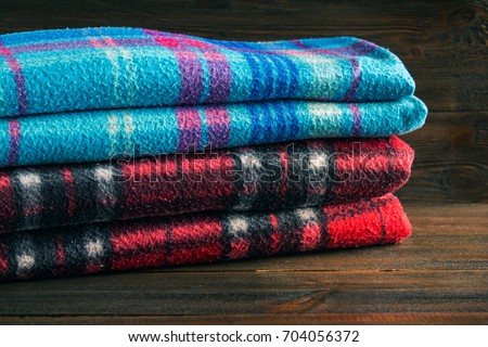 Winter fashion clothing with scarf gloves and blanket with wood background