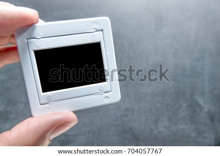 Holding film slide with chalkboard background