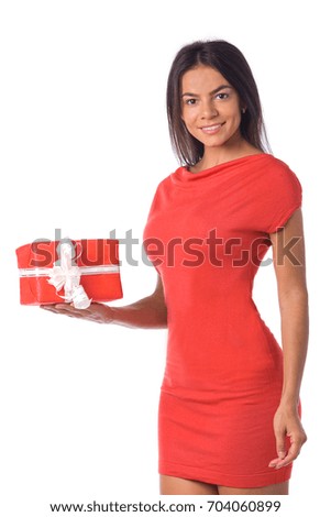 Close up portrait of smiling young woman holding decorated present in the right hand. Isolated on white background.