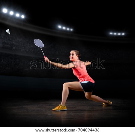 Young woman badminton player (in sports hall version) Royalty-Free Stock Photo #704094436
