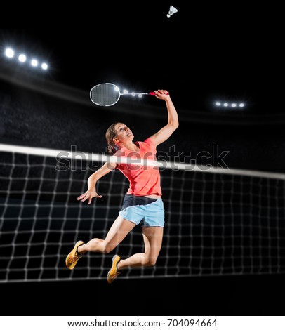 Young woman badminton player isolated (sports hall version) Royalty-Free Stock Photo #704094664