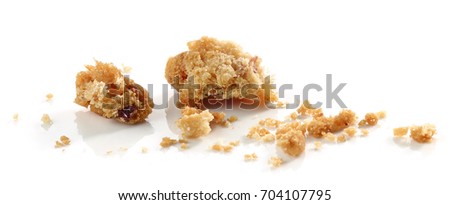 crumbs of cookie macro isolated on white background Royalty-Free Stock Photo #704107795